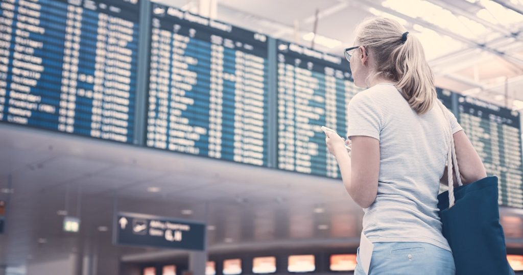 Women at the airport looking for flights to Accra